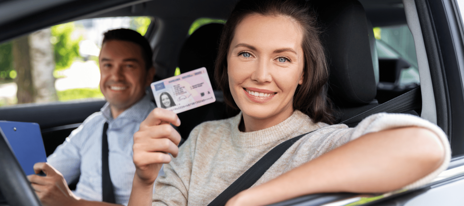 HHC und Führerschein 2024: Kann man wegen HHC seinen Führerschein verlieren? Frau zeigt ihrer Führerschein die Frau sitzt im Auto hat dunkle Haare links von ihr sitzt ein Mann der lächelt